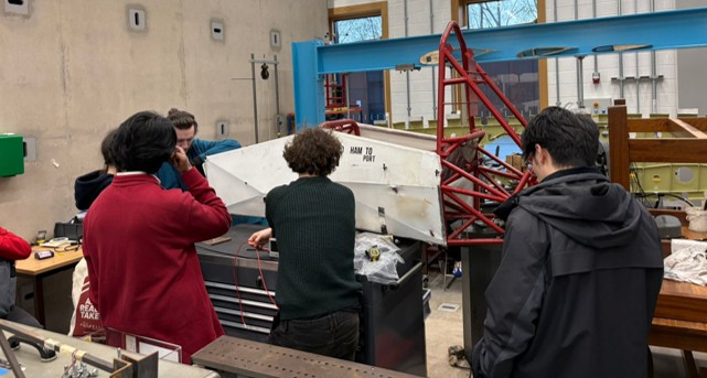 APC team members with the chassis in the workshop